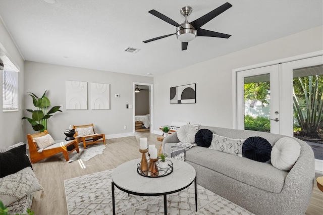 living room with french doors, light hardwood / wood-style floors, and ceiling fan