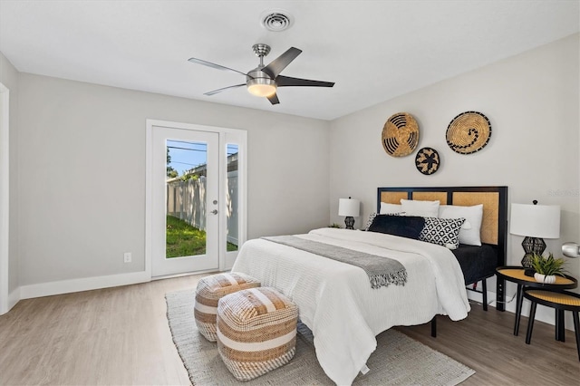 bedroom with access to exterior, wood-type flooring, and ceiling fan