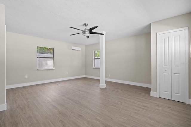 interior space with hardwood / wood-style floors, a textured ceiling, plenty of natural light, and ceiling fan