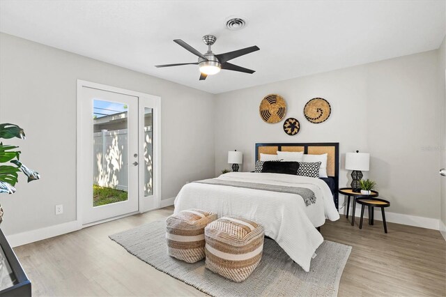 bedroom with ceiling fan, multiple windows, light hardwood / wood-style floors, and access to exterior