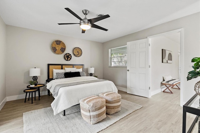 bedroom featuring light wood-type flooring, baseboards, and ceiling fan