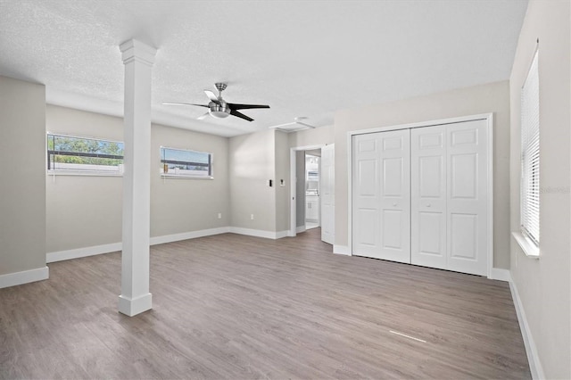 interior space with ceiling fan, a textured ceiling, and hardwood / wood-style floors