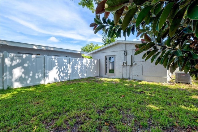 view of yard with fence and cooling unit