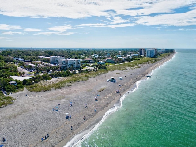 bird's eye view featuring a water view and a beach view