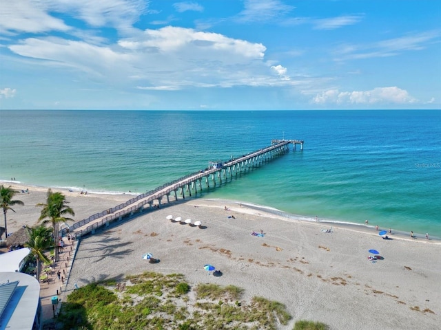 bird's eye view featuring a water view and a beach view