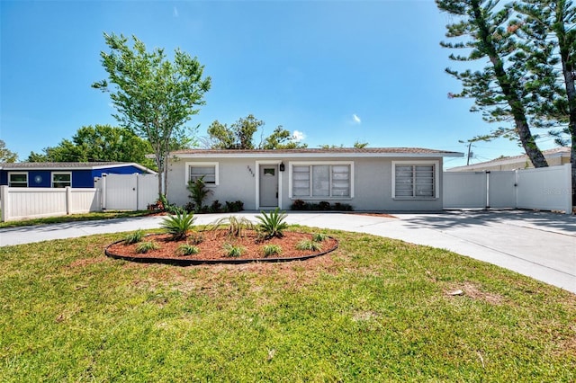 single story home with curved driveway, stucco siding, and a gate