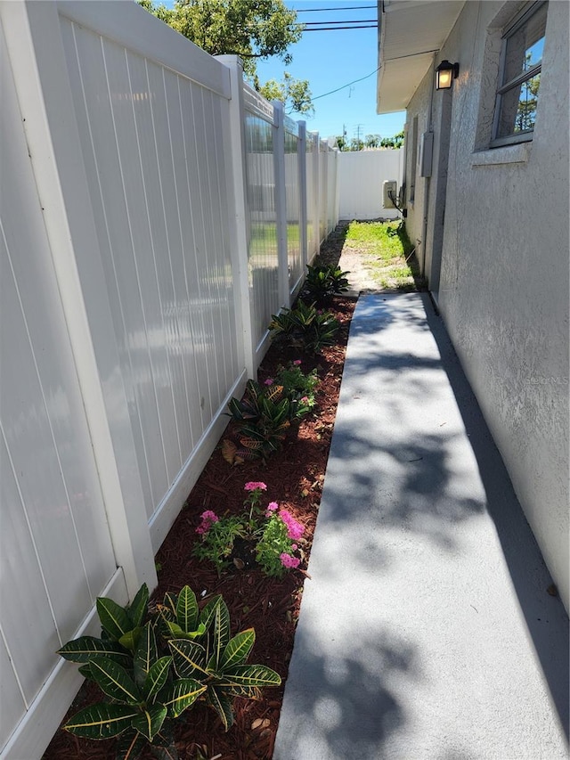exterior space with stucco siding and fence