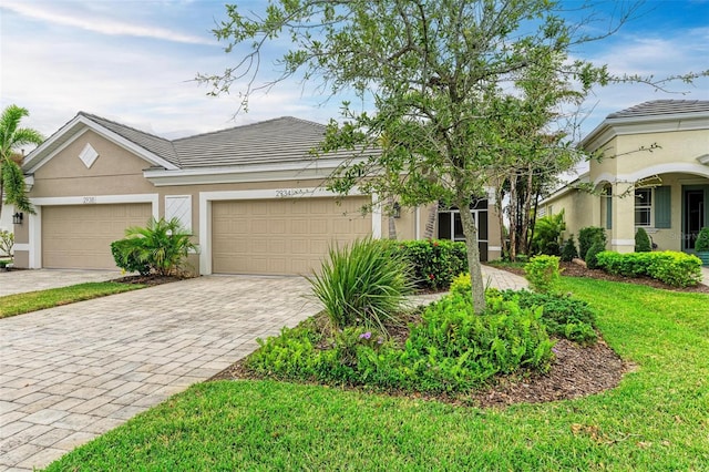 single story home featuring a front yard and a garage