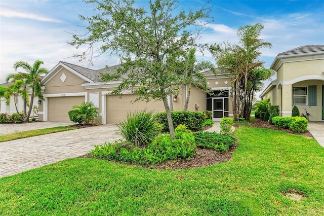 view of front of property featuring a front yard and a garage