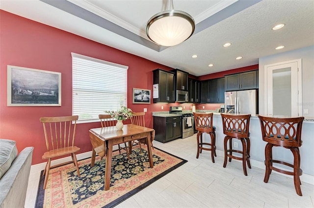 dining room featuring crown molding and a textured ceiling