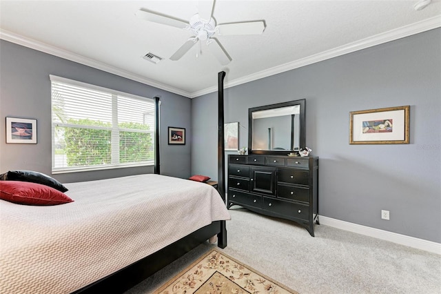 bedroom with ceiling fan, crown molding, and carpet