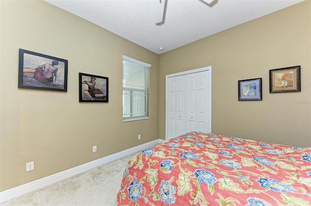 carpeted bedroom featuring a textured ceiling, a closet, and ceiling fan