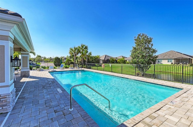 view of pool featuring a patio and a lawn