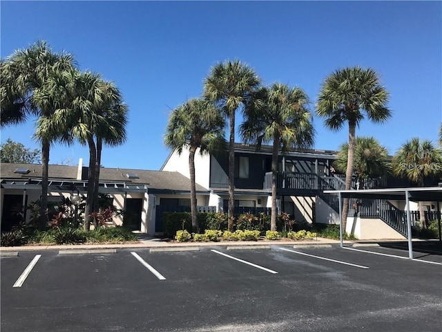 view of building exterior with uncovered parking