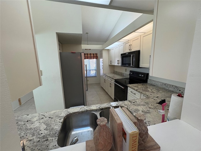 kitchen with light tile patterned floors, light stone countertops, lofted ceiling, black appliances, and white cabinetry