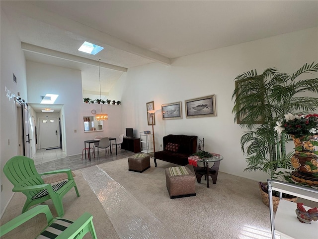 interior space featuring beamed ceiling, visible vents, high vaulted ceiling, an inviting chandelier, and a skylight