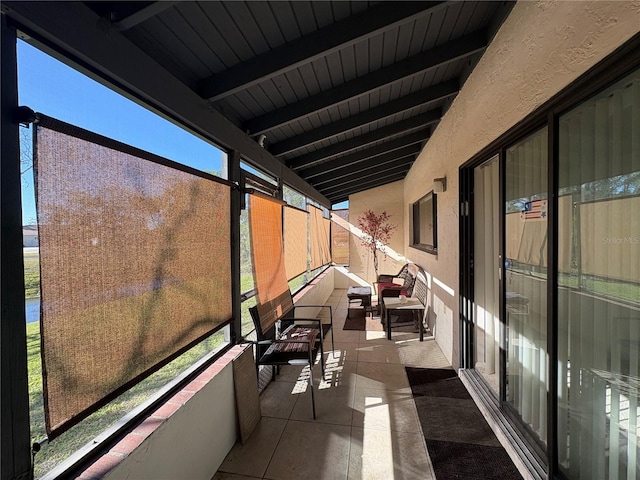 sunroom featuring beamed ceiling and wood ceiling