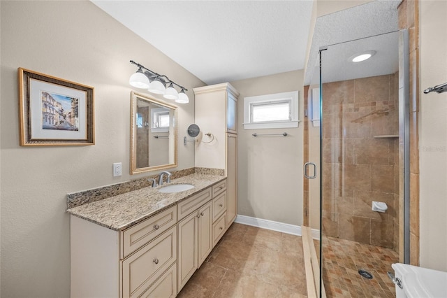 bathroom featuring an enclosed shower and vanity