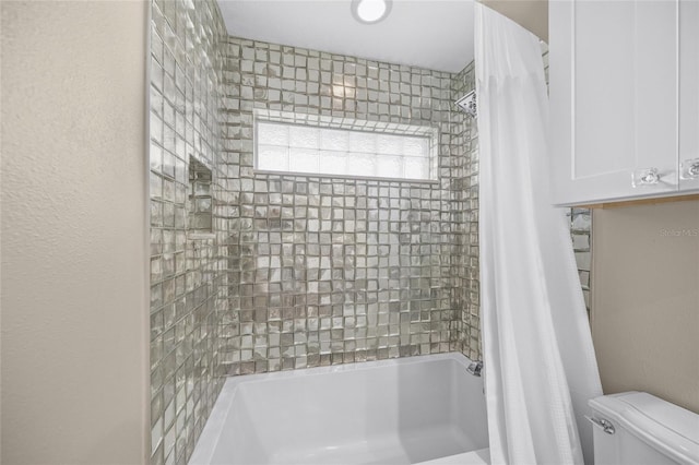 bathroom with shower / bath combo with shower curtain and toilet