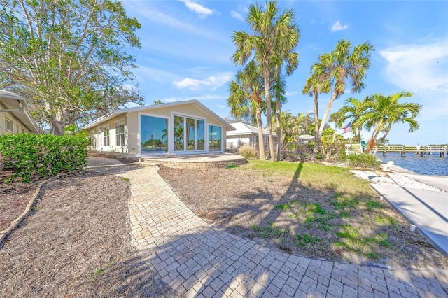 back of property featuring a water view