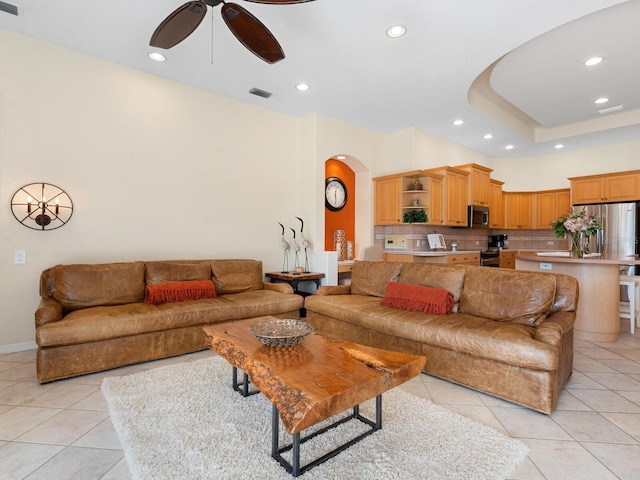 living room featuring ceiling fan and light tile patterned flooring