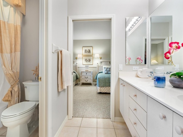 bathroom featuring vanity, toilet, and tile patterned flooring