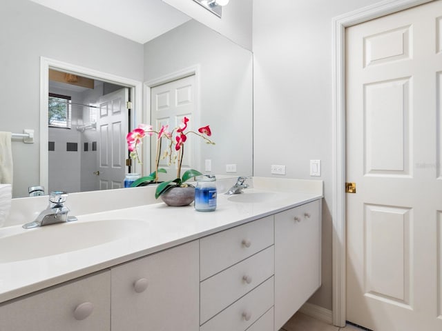 bathroom featuring vanity and tiled shower