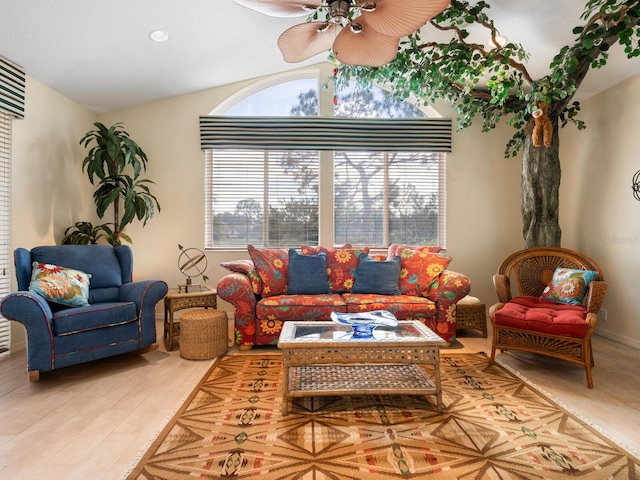 living room with ceiling fan, lofted ceiling, and light wood-type flooring