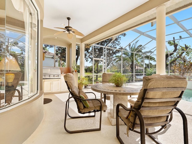 sunroom featuring ceiling fan