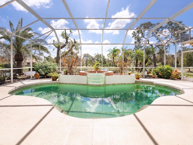 view of swimming pool featuring a patio area and a lanai