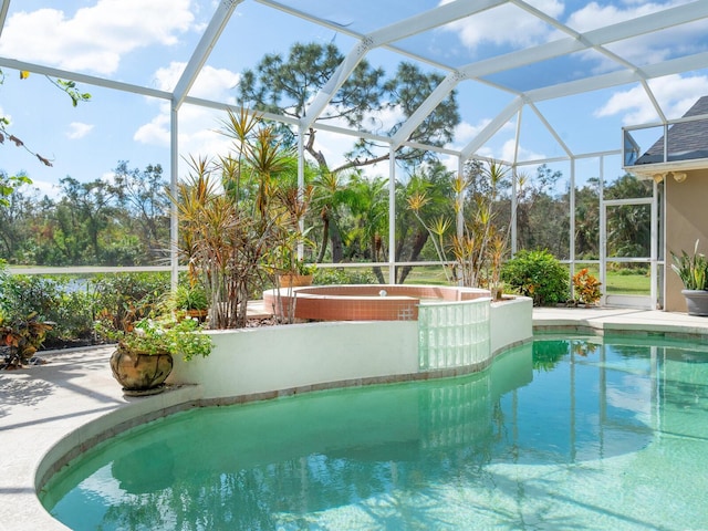 view of pool featuring an in ground hot tub and a lanai