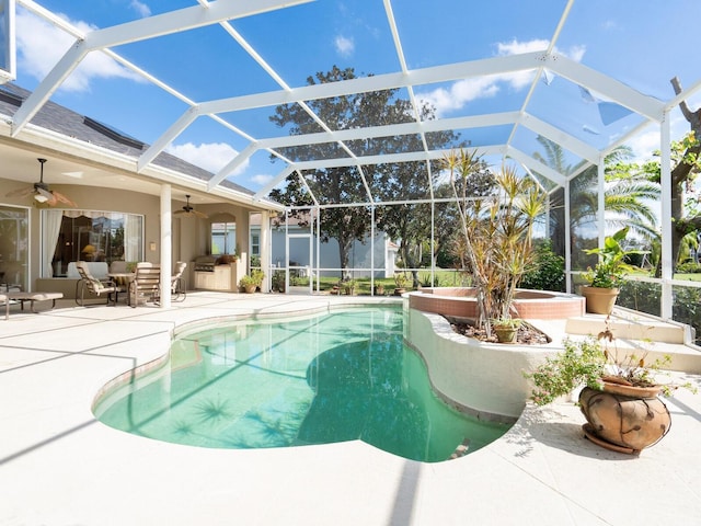 view of swimming pool with a patio area, a lanai, and ceiling fan