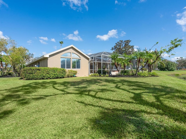 exterior space with a lawn and glass enclosure