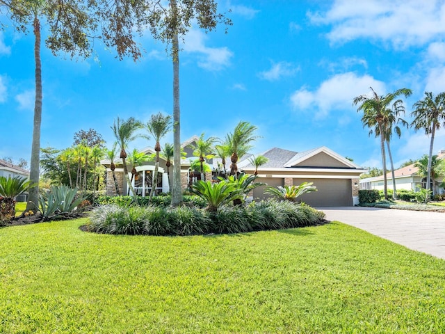 view of front of property with a front yard and a garage