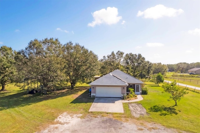 exterior space featuring a front yard, a garage, and a rural view