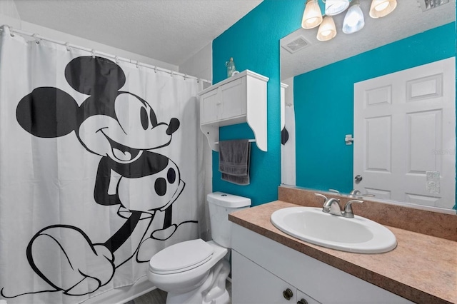 bathroom with vanity, toilet, a textured ceiling, and a shower with curtain