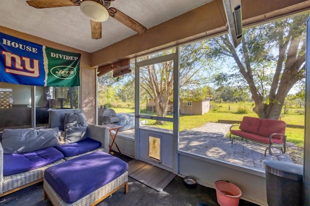 sunroom / solarium featuring ceiling fan