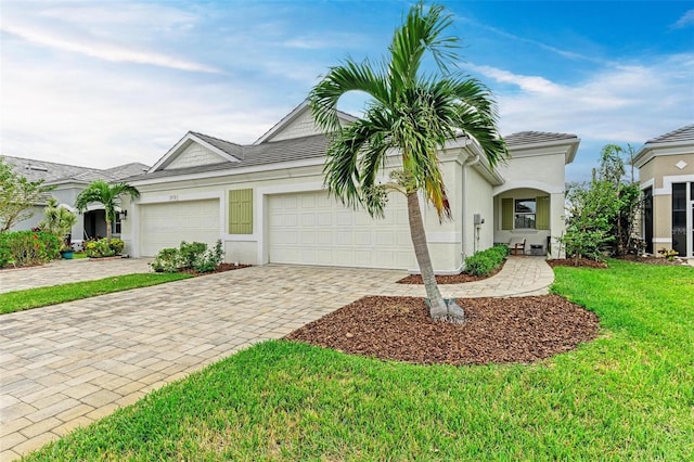 view of front facade with a front yard and a garage