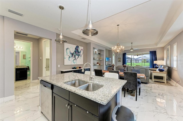 kitchen with dishwasher, sink, a center island with sink, and pendant lighting