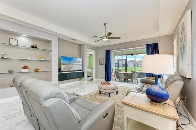 living room with built in features and ceiling fan