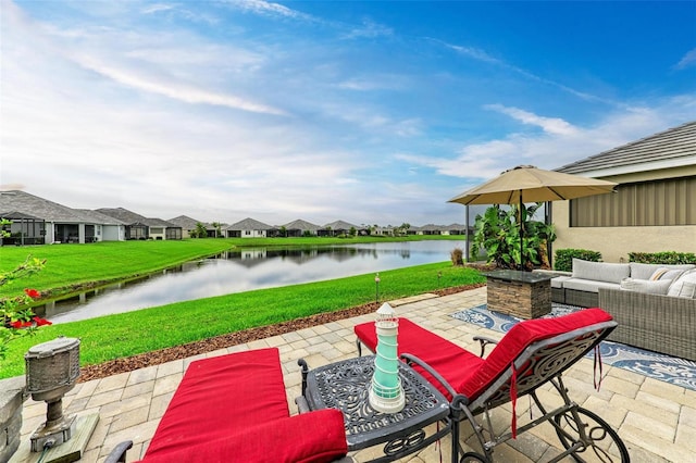 view of patio with a water view and outdoor lounge area