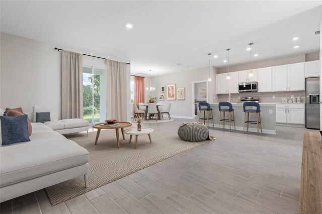 2938 Woodward Ave, North Port, FL 34286 - living room with light wood-style floors, recessed lighting, baseboards, and visible vents
