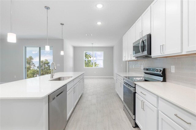 2938 Woodward Ave, North Port, FL 34286 - kitchen featuring decorative backsplash, a sink, baseboards, light countertops, and stainless steel appliances