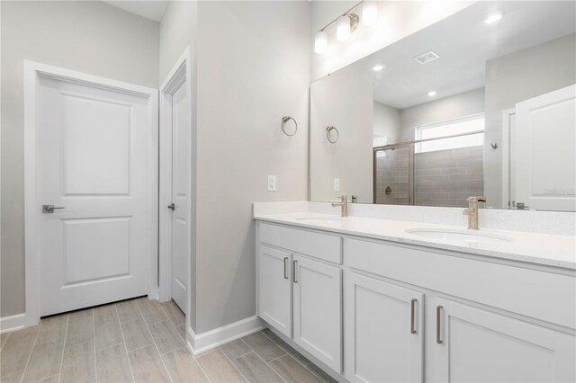 2938 Woodward Ave, North Port, FL 34286 - full bath featuring a sink, baseboards, a stall shower, and double vanity