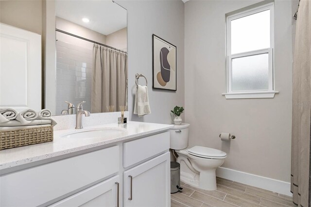 2938 Woodward Ave, North Port, FL 34286 - bathroom with vanity, toilet, baseboards, curtained shower, and wood tiled floor