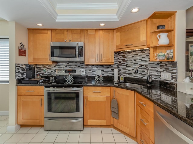 kitchen featuring ornamental molding, sink, stainless steel appliances, and dark stone countertops