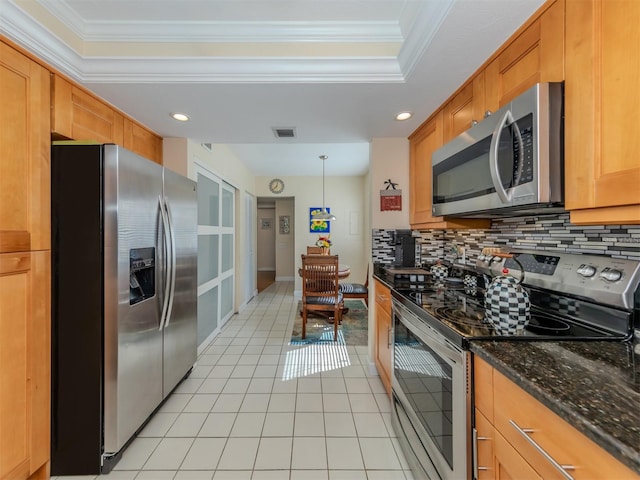 kitchen with ornamental molding, decorative backsplash, appliances with stainless steel finishes, and pendant lighting