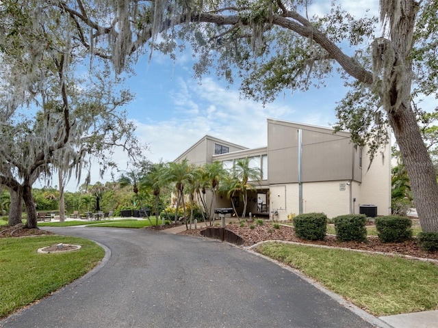 exterior space featuring central AC and a front yard