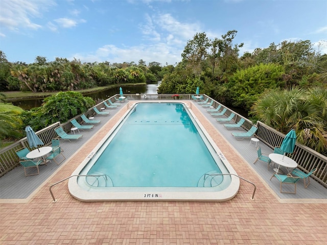 view of swimming pool with a water view