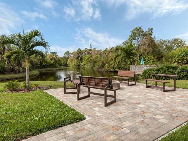 view of home's community featuring a water view, a patio, and a yard